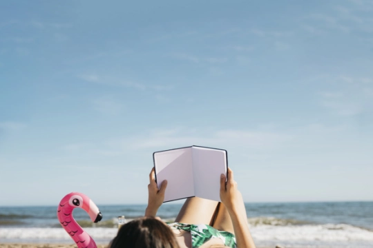 woman-reading-book-at-the-beach_23-2147813279.jpg
